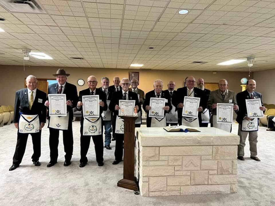Members displaying certificates of proficiency at a school of instruction